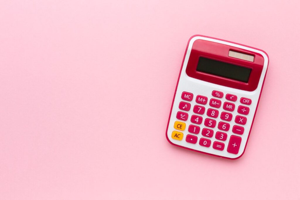 top-view-calculator-pink-background.
